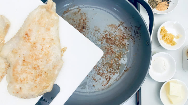 removing chicken to cutting board from pan