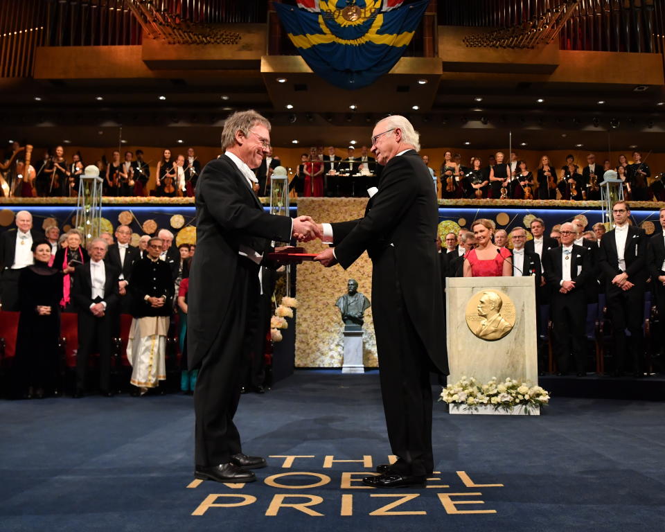 Physiology or Medicine laureate Sir Peter J. Ratcliffe, left, receives the prize from King Carl Gustaf of Sweden, during the Nobel Prize award ceremony at the Stockholm Concert Hall, in Stockholm, Tuesday, Dec. 10, 2019. (Jonas Ekstromer/TT News Agency via AP)