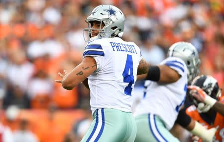 Sep 17, 2017; Denver, CO, USA; Dallas Cowboys quarterback Dak Prescott (4) prepares to pass the ball in the first quarter against the Denver Broncos at Sports Authority Field at Mile High. Ron Chenoy-USA TODAY Sports