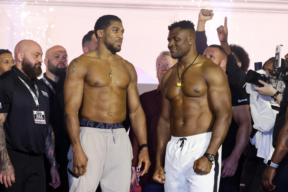 RIYADH, SAUDI ARABIA - MARCH 07: Anthony Joshua (L) and Francis Ngannou (R) interact at the weigh-in ahead of their 'Knockout Chaos' heavyweight fight at Greece in Boulevard World on March 07, 2024 in Riyadh, Saudi Arabia. (Photo by Richard Pelham/Getty Images)