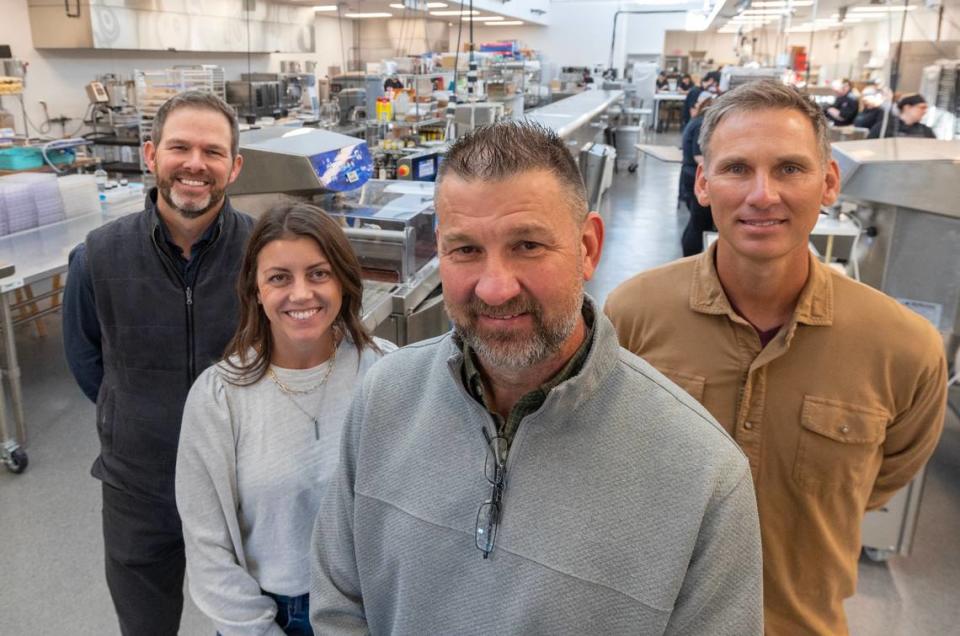 Wichita chocolatier Cocoa Dolce is expanding with a retail space in the new Fontainebleau Las Vegas resort and casino. The team behind the expansion is, from left, COO Ben Hesse, chief brand officer Amber Travis Millsap and the company’s owners, brothers Ben and Casey Voegeli. They’re standing in the company’s expanded production facility at the longtime Coleman Co. facility at the southwest corner of Second and St. Francis.