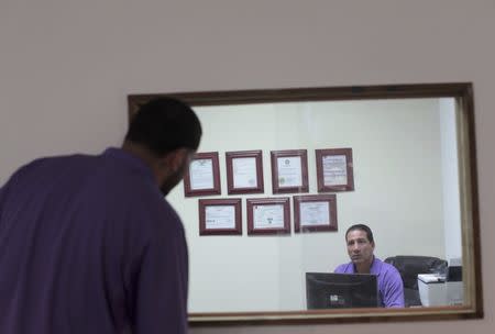 Government-issued licenses and permits hang at the offices of the Best Iguana Puerto Rico Meat company in San Juan, Puerto Rico, December 13, 2016. REUTERS/Alvin Baez