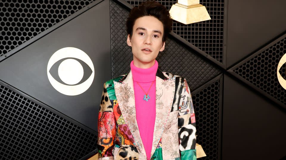 Singer-songwriter Jacob Collier was in a colorful patchwork suit paired with a pink turtleneck and blue flower necklace. - Frazer Harrison/Getty Images