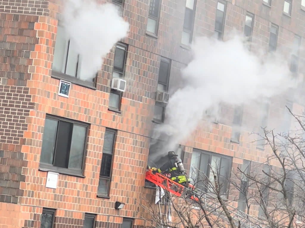 Smoke rises from an apartment building in New York City’s Bronx where 19 people were killed in a deadly blaze on Sunday  (Tanisha Ashe/via Reuters)