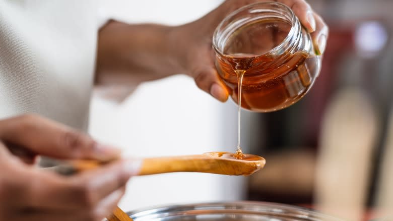 pouring honey into a spoon