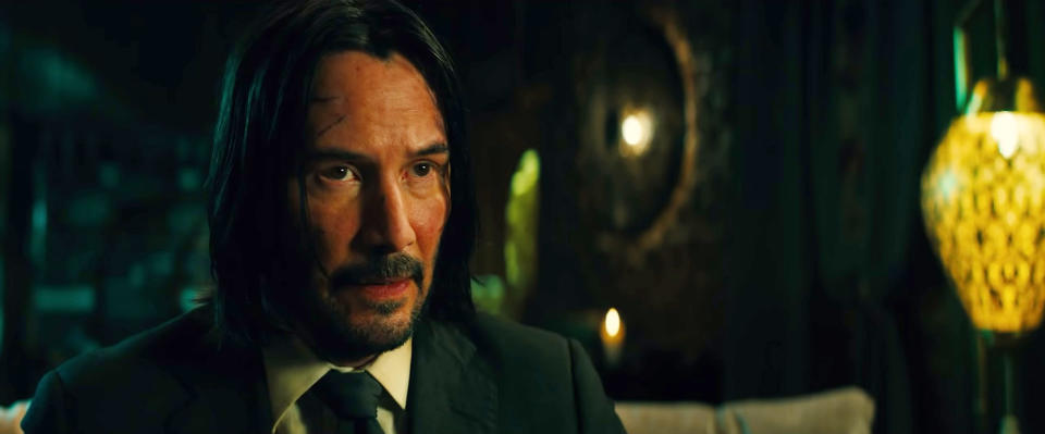 Keanu Reeves as John Wick with a bloodied face