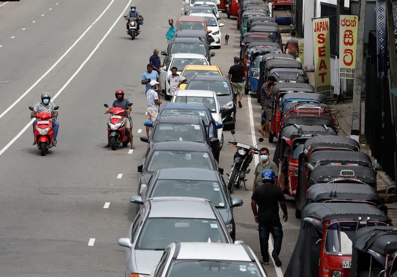 Drivers in their vehicles wait in a queue to buy petrol at a fuel station, amid the country's economic crisis in Colombo