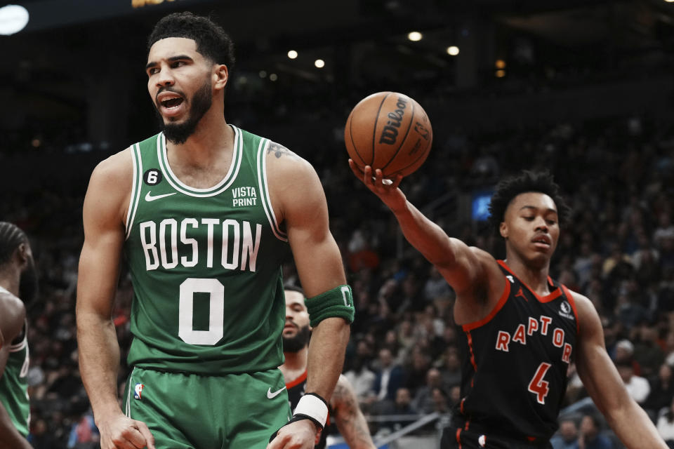 Boston Celtics forward Jayson Tatum (0) disputes a call as Toronto Raptors forward Scottie Barnes (4) looks on during the second half of an NBA basketball game in Toronto, Monday, Dec. 5, 2022. (Chris Young/The Canadian Press via AP)