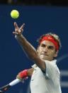 Roger Federer of Switzerland serves to Marinko Matosevic of Australia during their men's quarter-finals match at the Brisbane International tennis tournament in Brisbane, January 3, 2014. REUTERS/Jason Reed