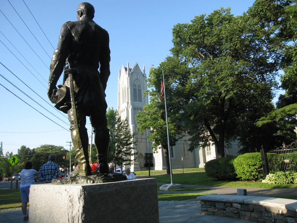 This July 12, 2012 photo shows a statue of Joshua Chamberlain and the First Parish Church in Brunswick, Maine. The church, a Gothic Revival building that dates to the 1840s, is one of 14 sites in Brunswick on the National Register of Historic Places. Worshippers at the church included “Uncle Tom’s Cabin” author Harriet Beecher Stowe, and Chamberlain, who led Union forces during the Civil War at the Little Round Top victory at the Battle of Gettysburg and who later accepted the Confederacy surrender at Appomattox in Virgina. (AP Photo/Beth Harpaz)
