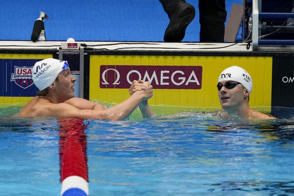 Nic Fink and Jake Foster react after their heat in the Men's 100 breaststroke preliminaries Saturday, June 15, 2024, at the US Swimming Olympic Trials in Indianapolis. (AP Photo/Darron Cummings)