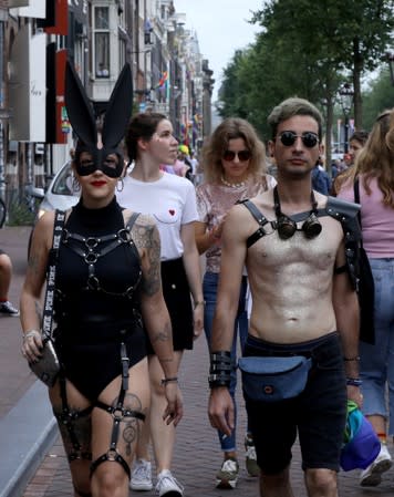 Participants walk along the canals during the annual gay pride parade in Amsterdam