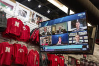 The Husker Hounds sports apparel store in Omaha, Neb., shows on television screens Wednesday, Sept. 16, 2020, a Big Ten virtual news conference to discuss the reopening of the football season. Less than five weeks after pushing football and other fall sports to spring in the name of player safety during the pandemic, the conference changed course Wednesday and said it plans to begin its season the Oct. 23-24 weekend. Each team will have an eight-game schedule. (AP Photo/Nati Harnik)