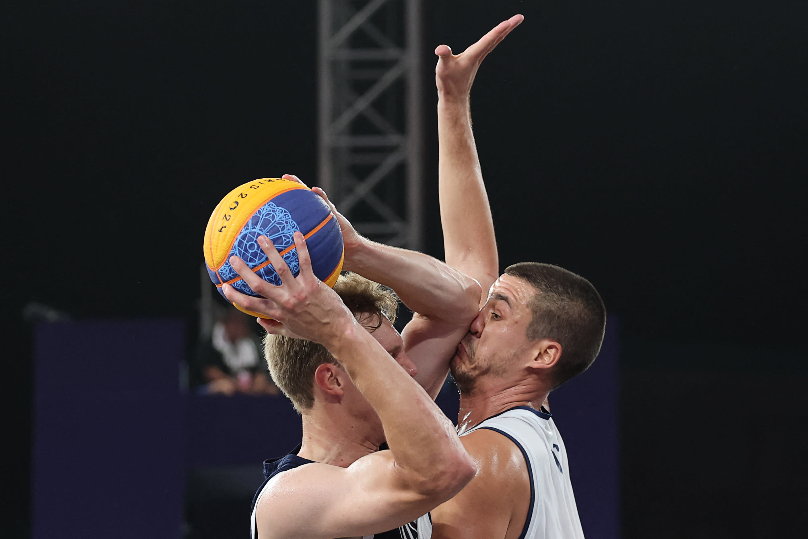 Serbia's #09 Mihailo Vasic (right) is hit in the nose by USA's Canyon Barry in 3x3 basketball. (Photo by David Gray/AFP via Getty Images)