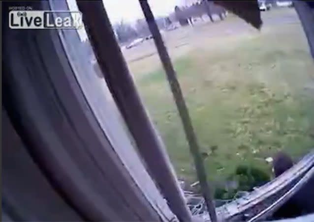 17-year-old Nicholas Hinchman jumped through the window, cutting himself and the waiting officer on broken glass as he fell. Source: LiveLeak/JThom