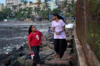 Maleesha Kharwa strolls with her cousin Liza Kharwa along a seashore in Mumbai