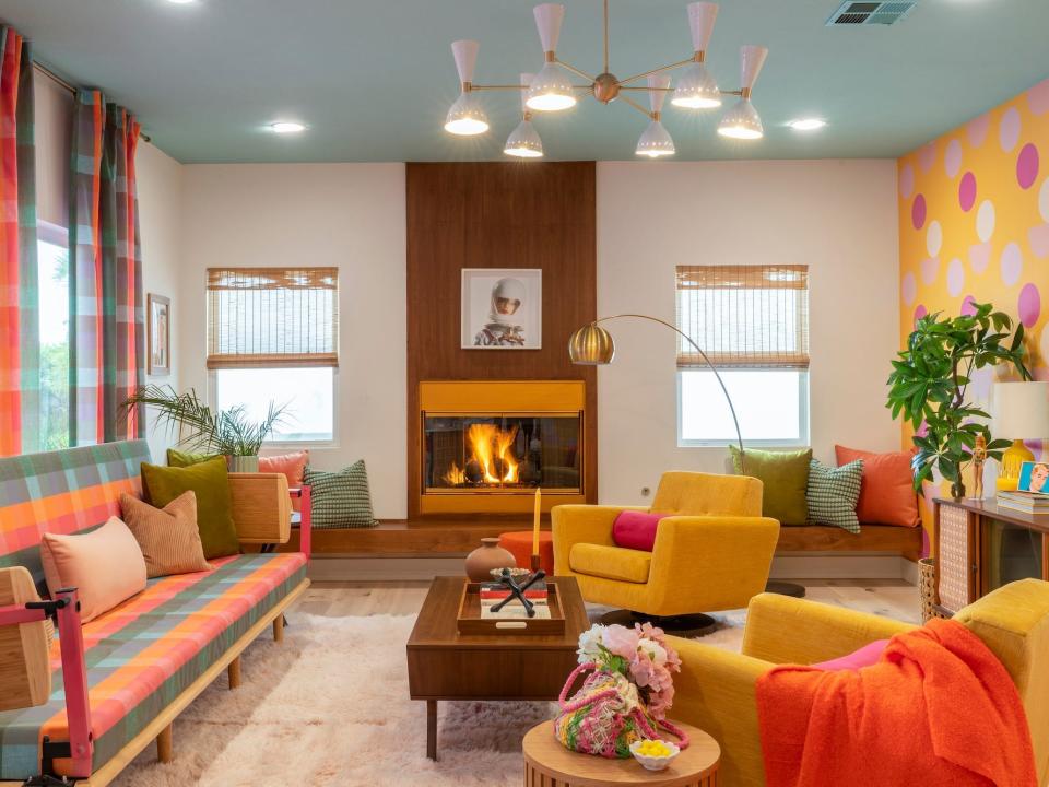 A living room with a retro fireplace and a checked couch.