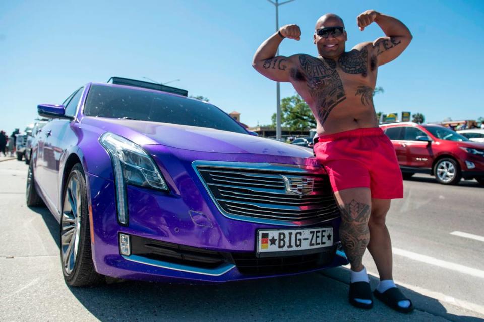 Zemarion “Big Zee” Meeks, of Charleston, Mississippi, poses with his purple Cadillac during Black Spring Break in Biloxi on Saturday, April 9, 2022.