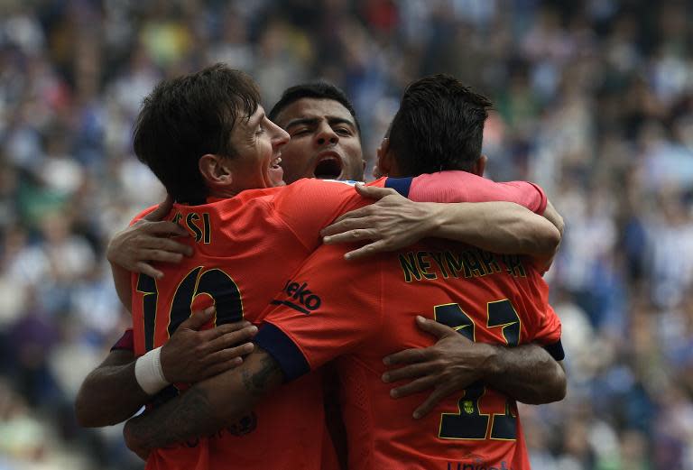 (From L) Barcelona's Lionel Messi, Rafinha and Neymar celebrate after scoring a goal during their Spanish La Liga match against Espanyol, at the Cornella-El Prat stadium in Cornella de Llobregat, on April 25, 2015