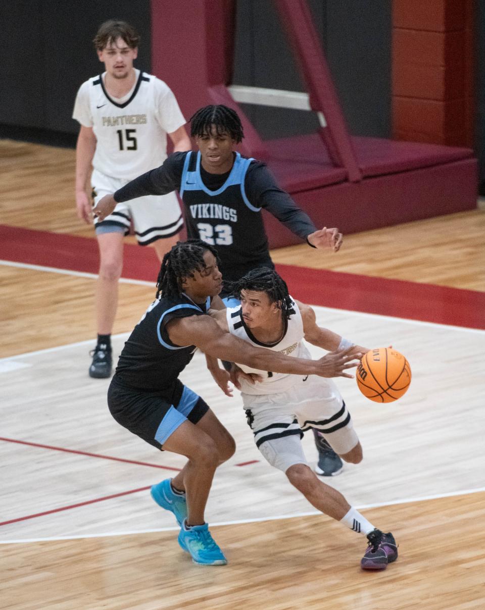 Christopher Jaylen McKinley (11) brings the ball up court during the Mary G. Montgomery vs Milton boys basketball game at Tate High School in Cantonment on Wednesday, Dec. 20, 2023.