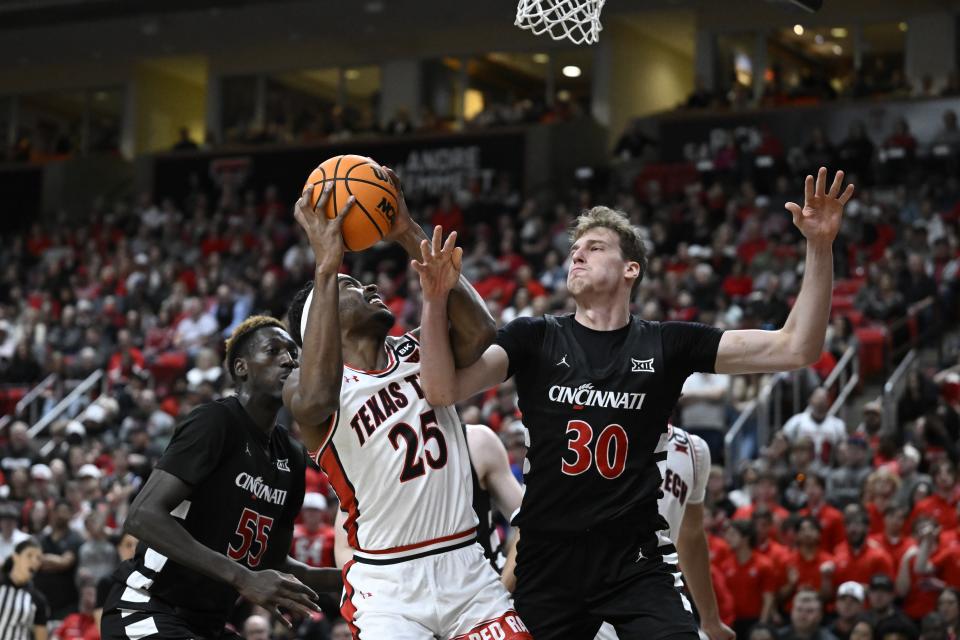 Texas Tech forward Robert Jennings (25) attempts to shoot against Cincinnati forward Viktor Lakhin (30) during the first half of an NCAA college basketball game, Saturday, Feb. 3, 2024, in Lubbock, Texas. (AP Photo/Justin Rex)