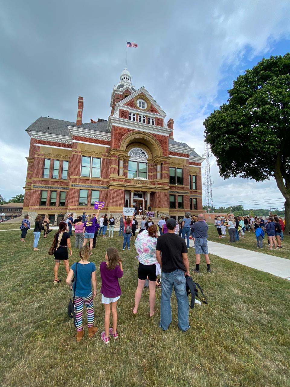 People attend a rally for missing Dee Warner Monday at the old Lenawee County Courthouse in Adrian.