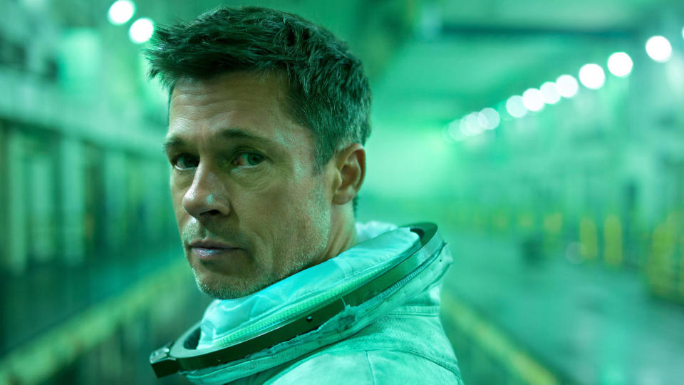 Brad Pitt examines a distant space station in “Ad Astra”