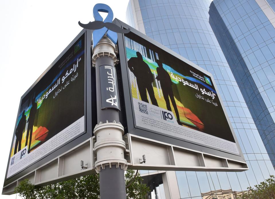 A billboard displaying an advert for Aramco is pictured in the Saudi capital Riyadh on November 10, 2019. - From robots to sniffer drones, Saudi Aramco has ramped up spending on technological innovation while its rivals cut back amid soft oil prices, but the energy giant risks losing its edge after its much-anticipated IPO. Saudi Arabia is offering a sliver of the company, touted as the kingdom's crown jewel, in its upcoming initial public offering that is the bedrock of Crown Prince Mohammed bin Salman's ambitious strategy to overhaul the oil-reliant economy. (Photo by FAYEZ NURELDINE / AFP) / The erroneous mention[s] appearing in the metadata of this photo by FAYEZ NURELDINE has been modified in AFP systems in the following manner: [november] instead of [october]. Please immediately remove the erroneous mention[s] from all your online services and delete it (them) from your servers. If you have been authorized by AFP to distribute it (them) to third parties, please ensure that the same actions are carried out by them. Failure to promptly comply with these instructions will entail liability on your part for any continued or post notification usage. Therefore we thank you very much for all your attention and prompt action. We are sorry for the inconvenience this notification may cause and remain at your disposal for any further information you may require. (Photo by FAYEZ NURELDINE/AFP via Getty Images)