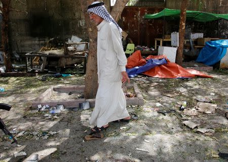 A man walks past at the site where a suicide bomber detonated his explosive vest at the entrance to Kadhimiya, a mostly Shi'ite Muslim district in northwest Baghdad, Iraq July 24, 2016. REUTERS/Khalid al Mousily