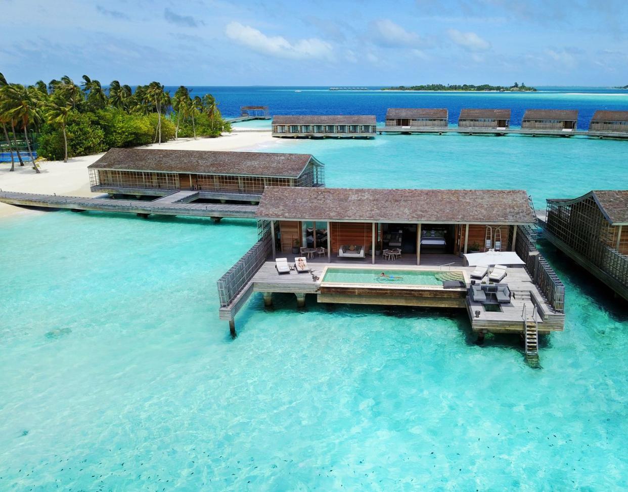 a group of buildings on a dock over a body of water