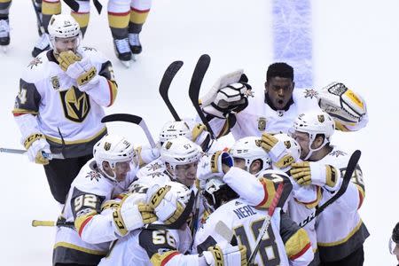 Oct 7, 2017; Glendale, AZ, USA; Vegas Golden Knights left wing James Neal (18) celebrates with teammates after scoring the game winning goal in overtime against the Arizona Coyotes at Gila River Arena. Mandatory Credit: Matt Kartozian-USA TODAY Sports