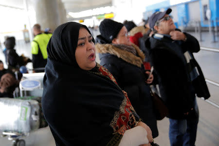 A woman waits for family to arrive at John F. Kennedy International Airport in Queens, New York, U.S., January 28, 2017. REUTERS/Andrew Kelly