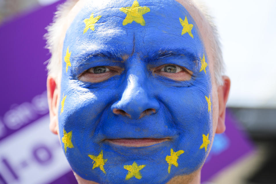 A man with his face painted like a European flag, attends a demonstration in Berlin, Germany, Sunday, May 19, 2019. People across Europe attend demonstrations under the slogan 'A Europe for All - Your Voice Against Nationalism'. (AP Photo/Markus Schreiber)