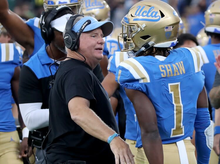 PASADENA, CALIF. - OCT. 23, 2021. UCLA defensive back Jay Shaw is congratulated by head coach Chip Kelly.