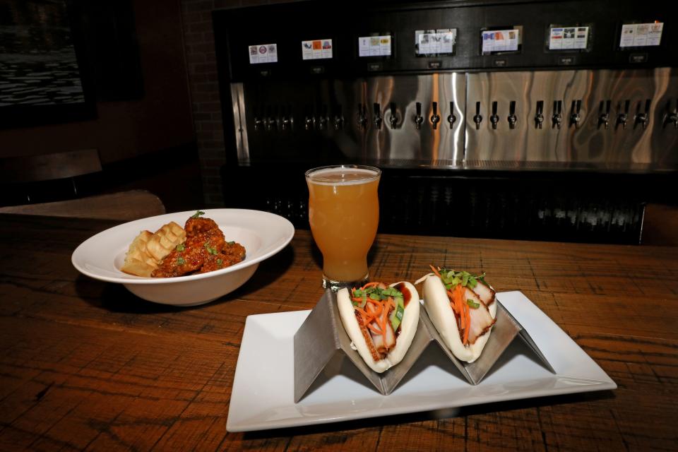 Waffle wings with a garlic butter sauce and pork belly bar buns at Mekong District One, the new self-pour taproom that's now part of the Vietnamese restaurant Mekong District in Nyack, Aug. 25, 2023.