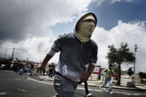 Palestinians ready to throw stones as clashes break out during the funeral of a Palestinian teenager. Around 2,000 mourners laid the body of a Palestinian teenager killed in Jerusalem clashes to rest on Saturday as Israeli police kept a discreet watch but did not intervene, fearing more unrest