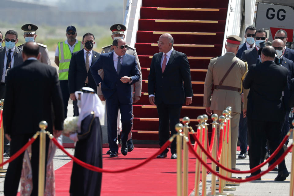 Iraqi President Barham Salih, center right, welcomes Egyptian President Abdel Fattah el-Sissi, center left, upon his arrival at Baghdad Airport, Iraq, Sunday, June 27, 2021. (AP Photo/Khalid Mohammed)