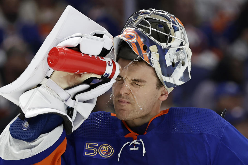 New York Islanders goaltender Ilya Sorokin sprays his face with water in the first period of an NHL hockey game against the Philadelphia Flyers on Saturday, April 8, 2023, in Elmont, N.Y. (AP Photo/Adam Hunger)