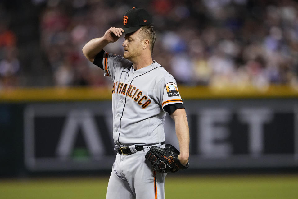 San Francisco Giants starting pitcher Alex Cobb adjusts his cap after the Arizona Diamondbacks scored two runs during the second inning of a baseball game, Tuesday, Sept. 19, 2023, in Phoenix. (AP Photo/Matt York)