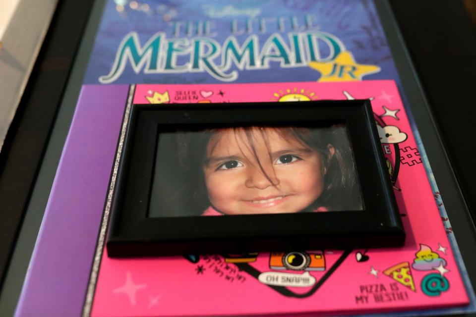 A photograph of Sarah Radney on top of a scrapbook she made and a poster signed by the cast and crew of her middle school's play. Radney was 11-years-old when she was killed by debris from Hurricane Michael in Oct. 2018. 