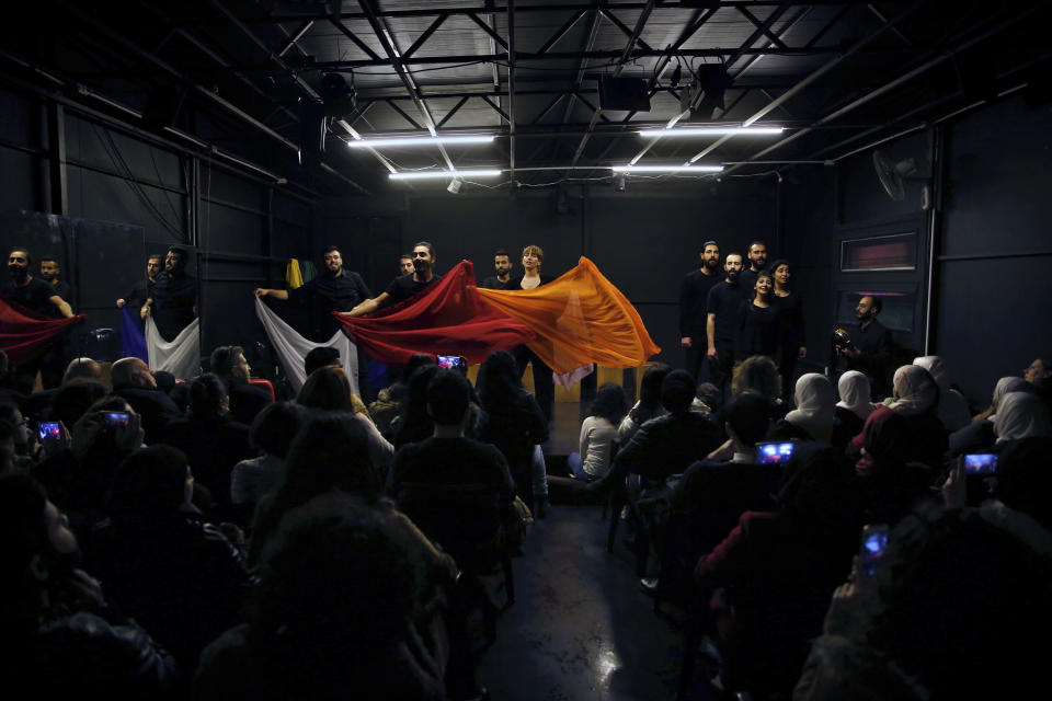 In this Friday, Feb. 8, 2019 photo, a team of Syrian actors take part in a playback theater at the end of a three-month training session, in Beirut, Lebanon. Syrians from different parts of their war-torn country have gathered inside a theater telling their stories that are later re-acted by a group of Syrians who have been training on playback theater. (AP Photo/Bilal Hussein)