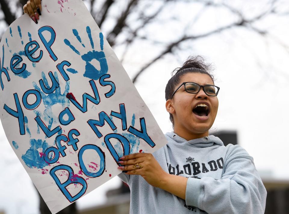 Roosevelt student Jayla Jo, 18, yells toward passing cars while holding a sign that says "keep your laws off my body" outside Planned Parenthood on Thursday, May 5, 2022, in Sioux Falls after a draft decision to overturn Roe v. Wade was leaked from the Supreme Court. "A lot of people think that we're so young that we can't have an opinion on this, but I think this affects teenagers a lot," said Jo. "Our generation is the future, our generation is the ones who will be here in the long run."