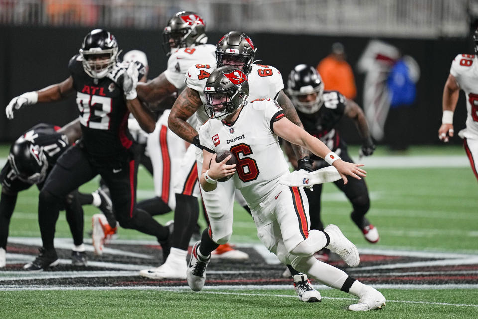 Tampa Bay Buccaneers quarterback Baker Mayfield (6) scrambles out of the pocket during the first half of an NFL football game against the Atlanta Falcons, Sunday, Dec. 10, 2023, in Atlanta. (AP Photo/Mike Stewart)