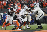 Las Vegas Raiders quarterback Derek Carr (4) is sacked by Cincinnati Bengals' Sam Hubbard (94) during the first half of an NFL wild-card playoff football game, Saturday, Jan. 15, 2022, in Cincinnati. (AP Photo/AJ Mast)