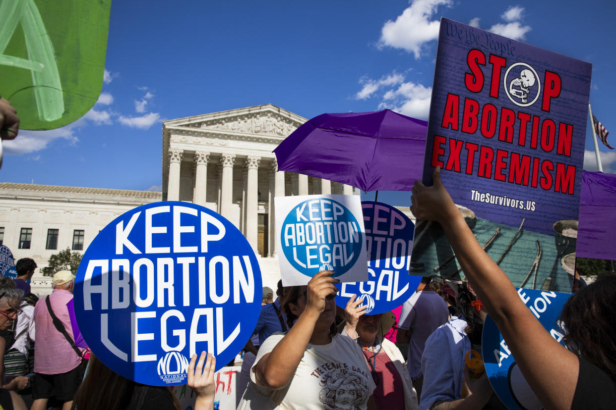 Abortion rights advocates and anti-abortion activists protest in front of the Supreme Court.