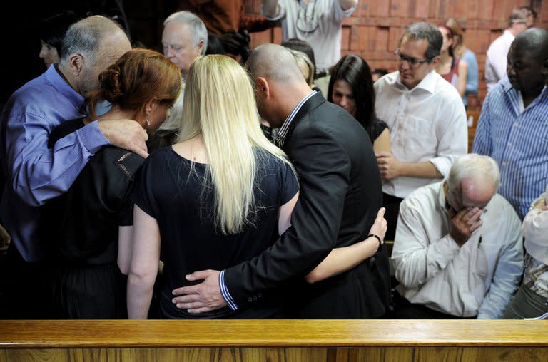 The father of South African Olympic sprinter Oscar Pistorius, Henke (right), reacts as relatives comfort each other on February 19, 2013 after his bail hearing in Pretoria was adjourned. "Blade Runner" Oscar Pistorius returned to court Wednesday to hear explosive allegations that he fought "non-stop" with his slain girlfriend Reeva Steenkamp on the night of her killing