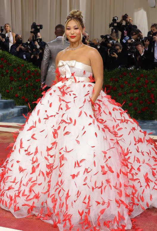 Chloe Kim in a white gown with feathers adorning the big poofy part