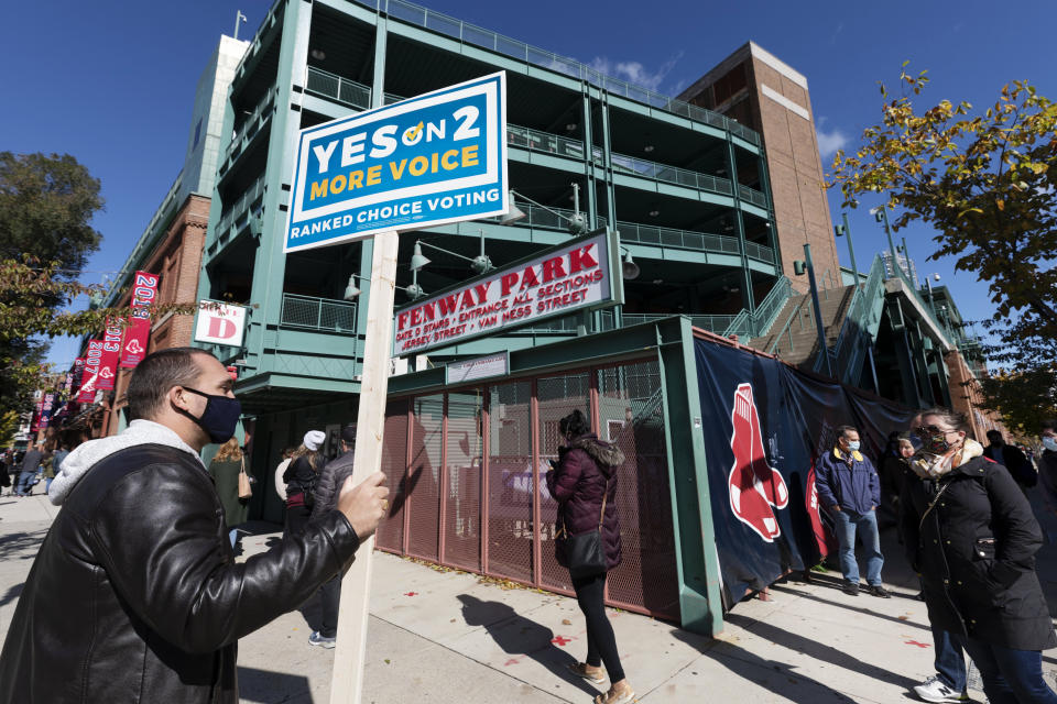 People wait in line to vote at Fenway Park, Saturday, Oct. 17, 2020, in Boston. (AP Photo/Michael Dwyer)