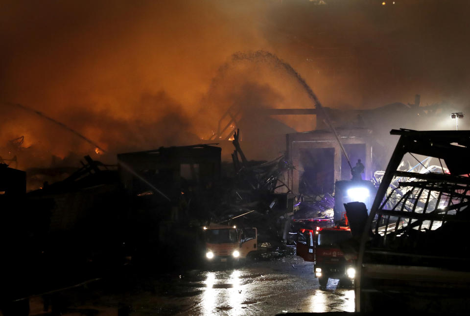 Firefighters extinguish a fire in warehouses at the seaport of Beirut, Lebanon, Thursday, Sept. 10. 2020. A huge fire broke out Thursday at the Port of Beirut, triggering panic among residents traumatized by last month's massive explosion that killed and injured thousands of people. (AP Photo/Hussein Malla)