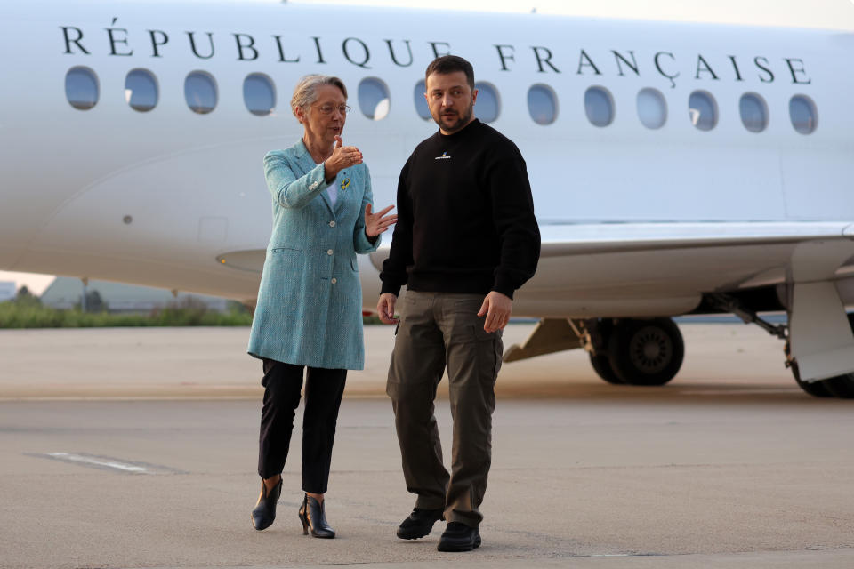 Ukrainian President Volodymyr Zelenskyy is welcomed by French Prime minister Elisabeth Borne upon his arrival at Villacoublay Air Base, southwest of Paris, Sunday, May 14, 2023. Ukrainian President Volodymyr Zelenskyy makes a surprise visit to Paris for talks Sunday night with French President Emmanuel Macron, extending a multi-stop European tour that has elicited fresh pledges of military support as his country gears up for a counteroffensive against Russian occupation forces. (Thomas Samson, Pool via AP)